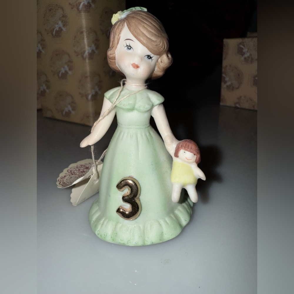 Charming Green Figurine with Doll